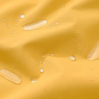 Close-up of water droplets on a yellow fabric surface