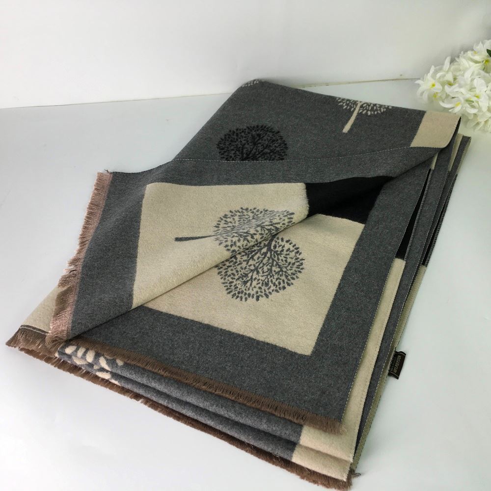 Folded fabric with leaf pattern on a white surface