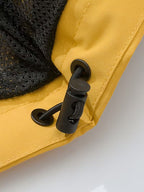 Close-up of a yellow fabric with a black zipper on a white background