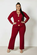 Woman wearing a red outfit with gold buttons on a white background