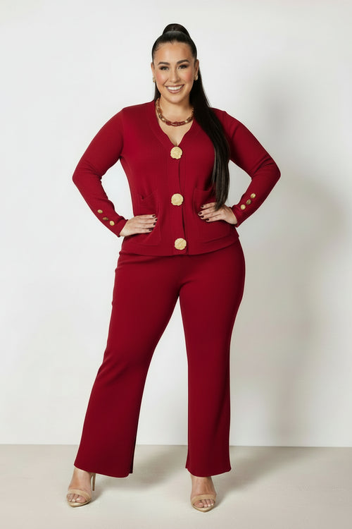 Woman wearing a red outfit with gold buttons on a white background