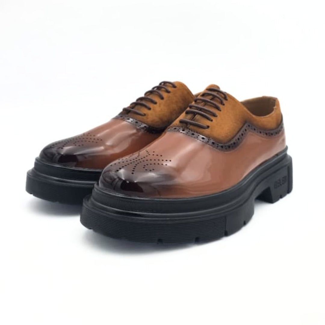 Brown leather shoes with black soles on a white background