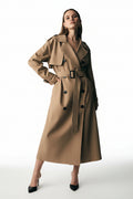 Woman wearing a beige trench coat on a white background
