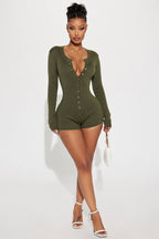 Woman wearing a green bodysuit on a white background
