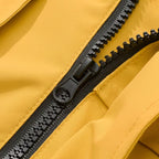 Close-up of a black zipper on a yellow fabric background