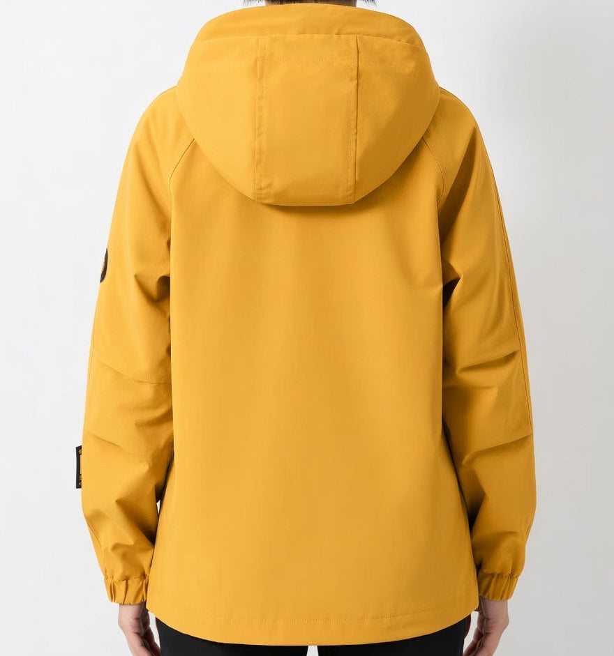 Yellow raincoat worn by a person on a white background
