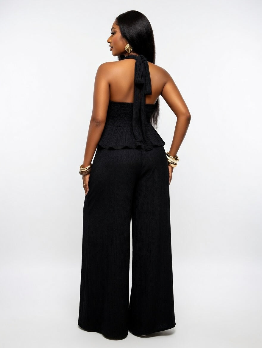 Woman wearing a black jumpsuit on a white background