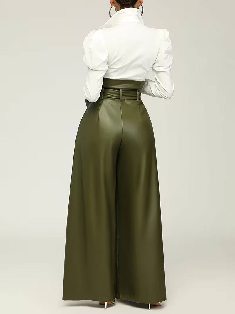 Person wearing a white shirt and olive green wide-leg pants on a plain background