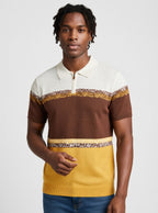Man wearing a brown, yellow, and white striped sweater on a plain background