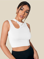 Woman wearing a white sleeveless top against a beige background