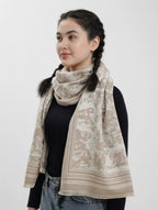 Woman wearing a beige patterned scarf on a white background