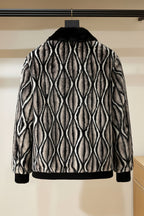 Patterned jacket with black collar hanging on a rack against a neutral background