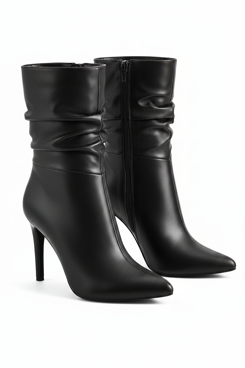 Pair of black high-heeled boots on a white background