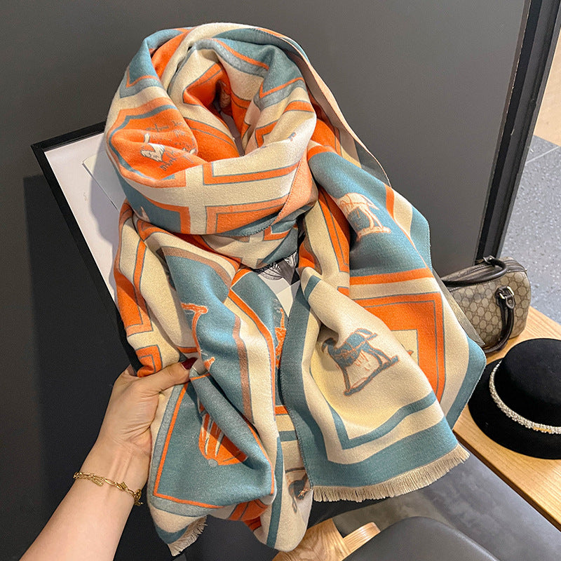 Colorful patterned scarf held by a hand with a neutral background