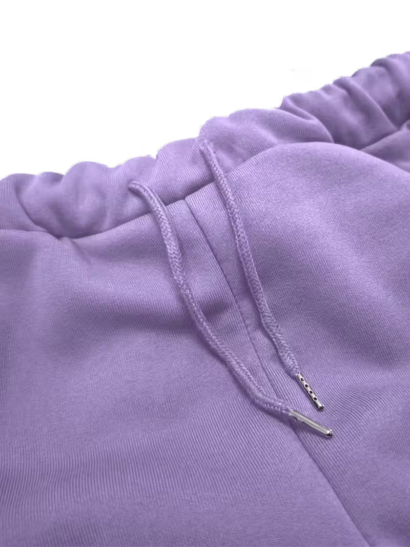 Close-up of a purple sweatshirt with drawstring detail on a white background