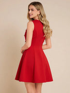 Woman wearing a red dress against a beige background