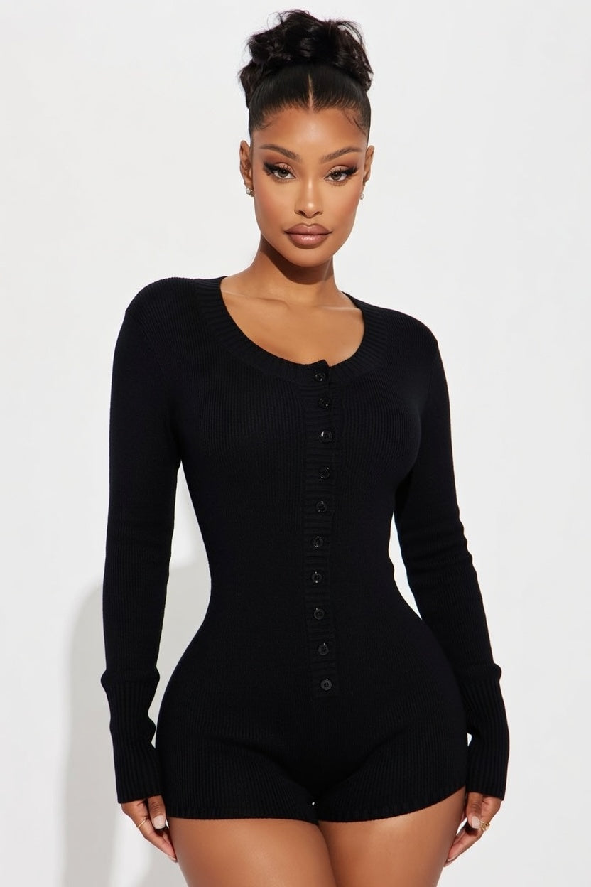 Woman wearing a black long-sleeve bodysuit against a white background