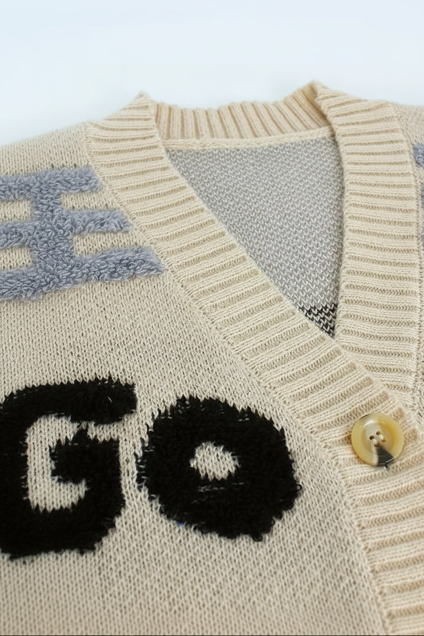 Close-up of a sweater with text and a button featuring a dog illustration.