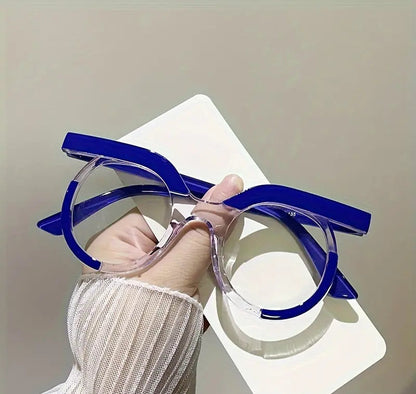 Blue and clear eyeglasses held by a hand on a white background