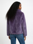 Person wearing a purple textured jacket on a white background