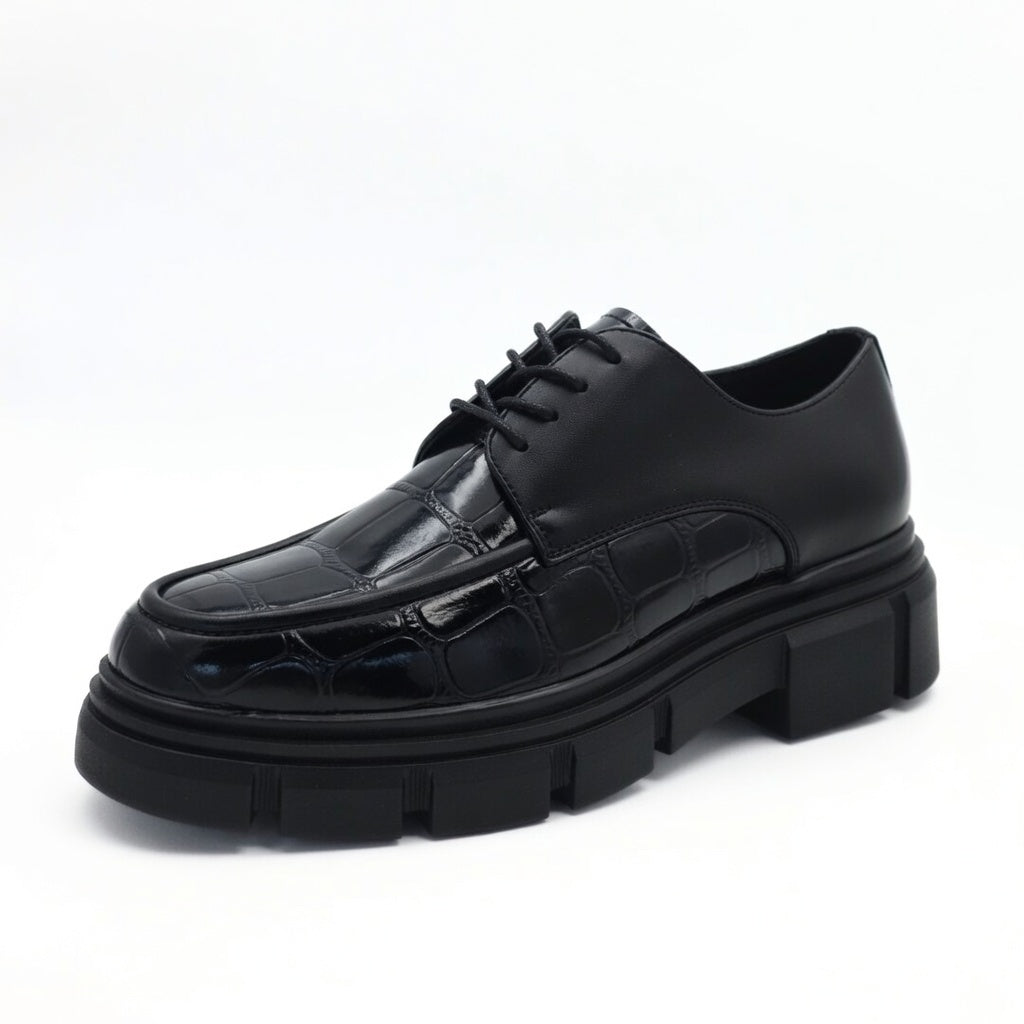 Black leather shoe with thick sole on a white background