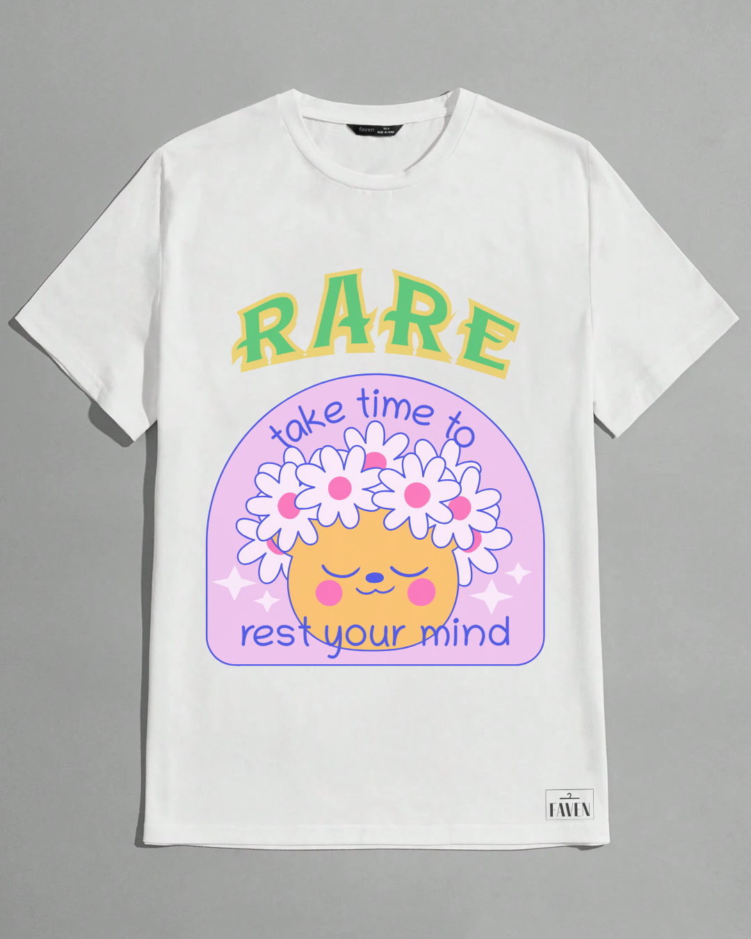 White t-shirt with a colorful graphic design featuring text and a cartoon face on a gray background