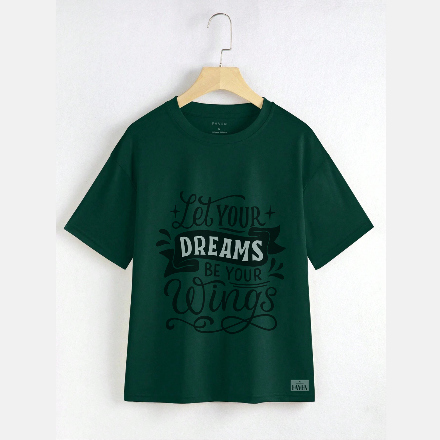 Green t-shirt with motivational quote on a hanger against a white background