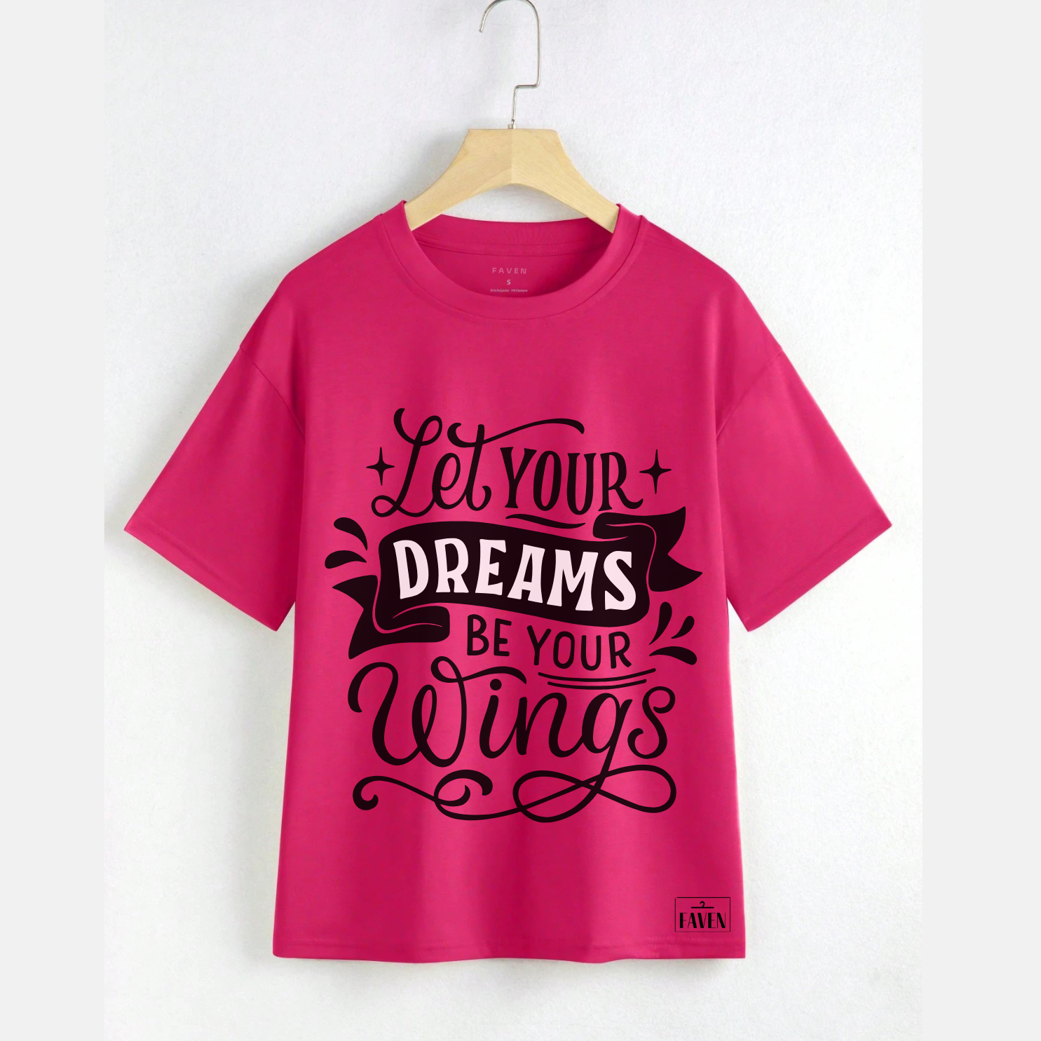 Pink t-shirt with motivational quote on a hanger against a white background