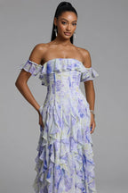 Woman wearing a floral off-shoulder dress against a gray background