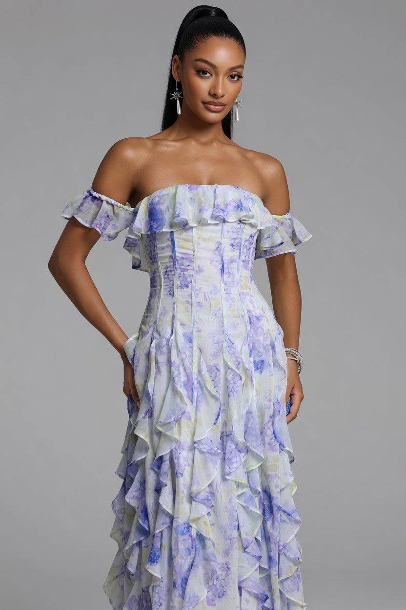 Woman wearing a floral off-shoulder dress against a gray background