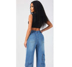 Woman wearing blue jeans and a black top on a white background