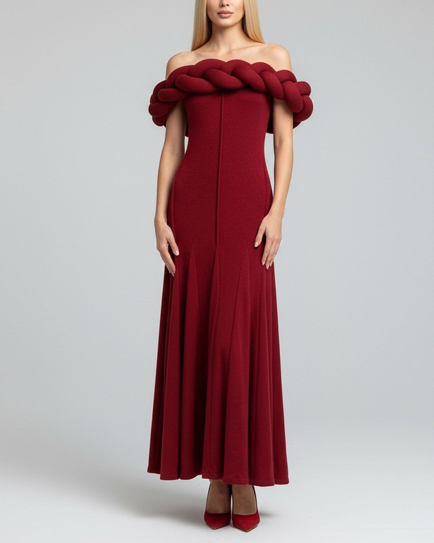Red off-shoulder dress with braided detail on a gray background