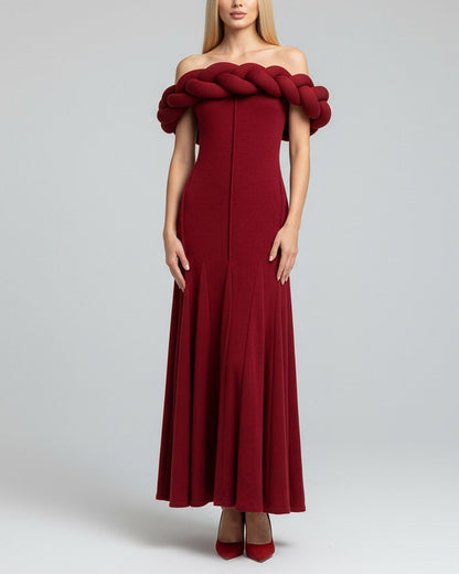 Red off-shoulder dress with braided detail on a gray background