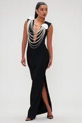 Black evening gown with pearl embellishments on a white background