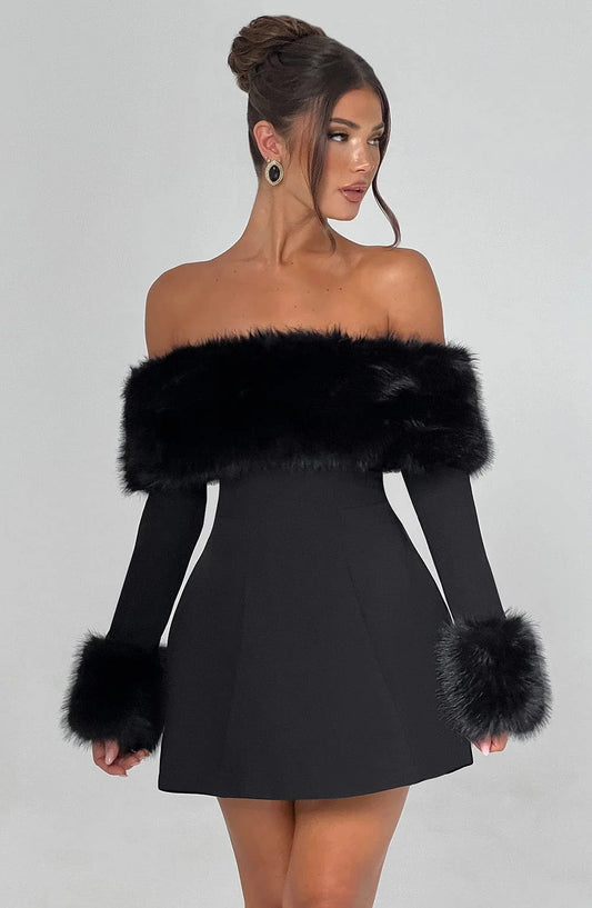 Black off-shoulder dress with fur trim worn by a model on a gray background