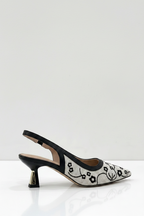 Black and white patterned high-heeled shoe on a white background