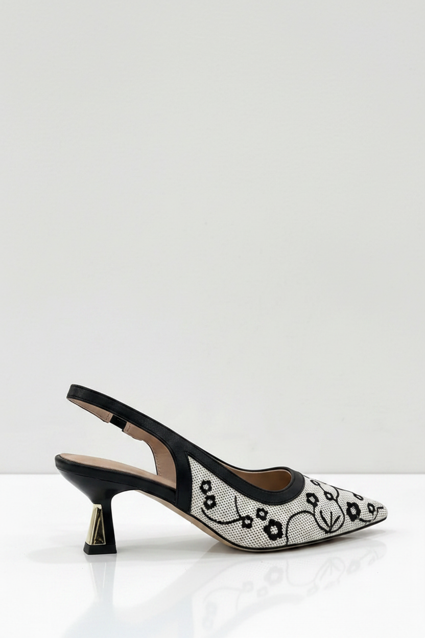 Black and white patterned high-heeled shoe on a white background