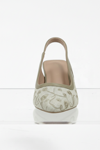 High-heeled shoe with decorative sole on a white background