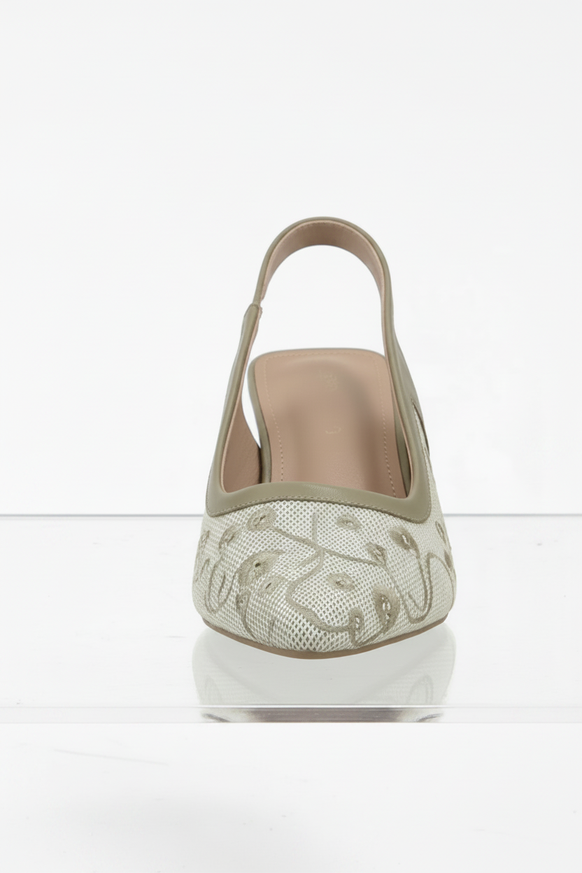 High-heeled shoe with decorative sole on a white background