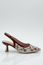 High-heeled shoe with floral design on a white background