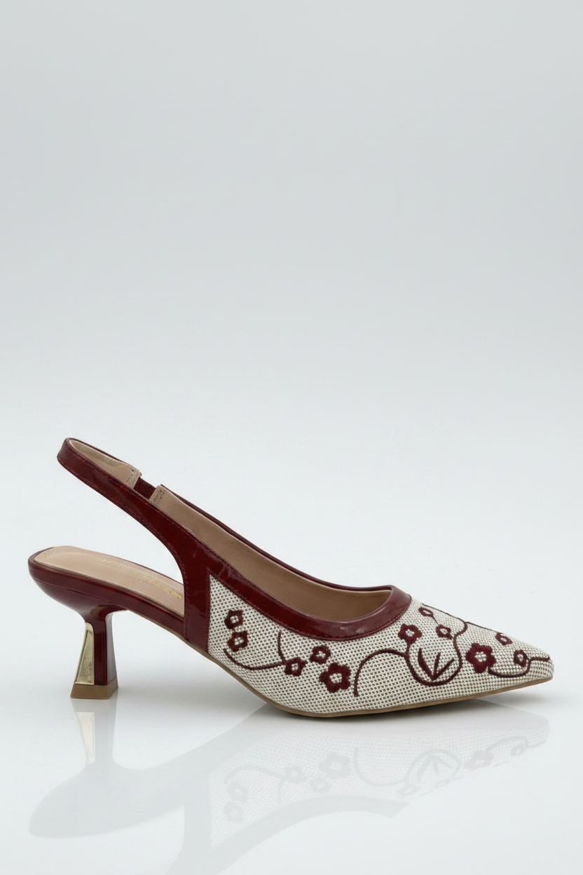High-heeled shoe with floral design on a white background