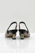 Pair of high-heeled shoes with decorative patterns on a white background