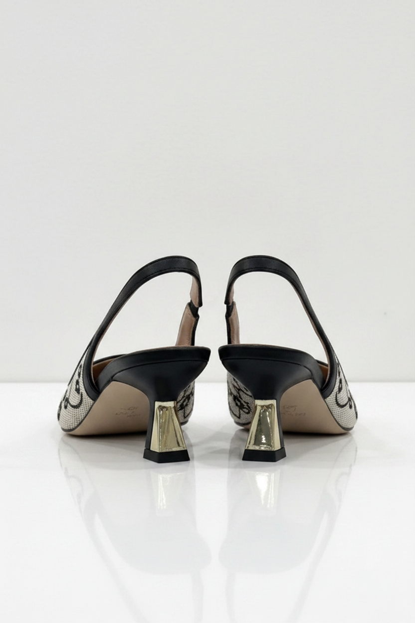 Pair of high-heeled shoes with decorative patterns on a white background