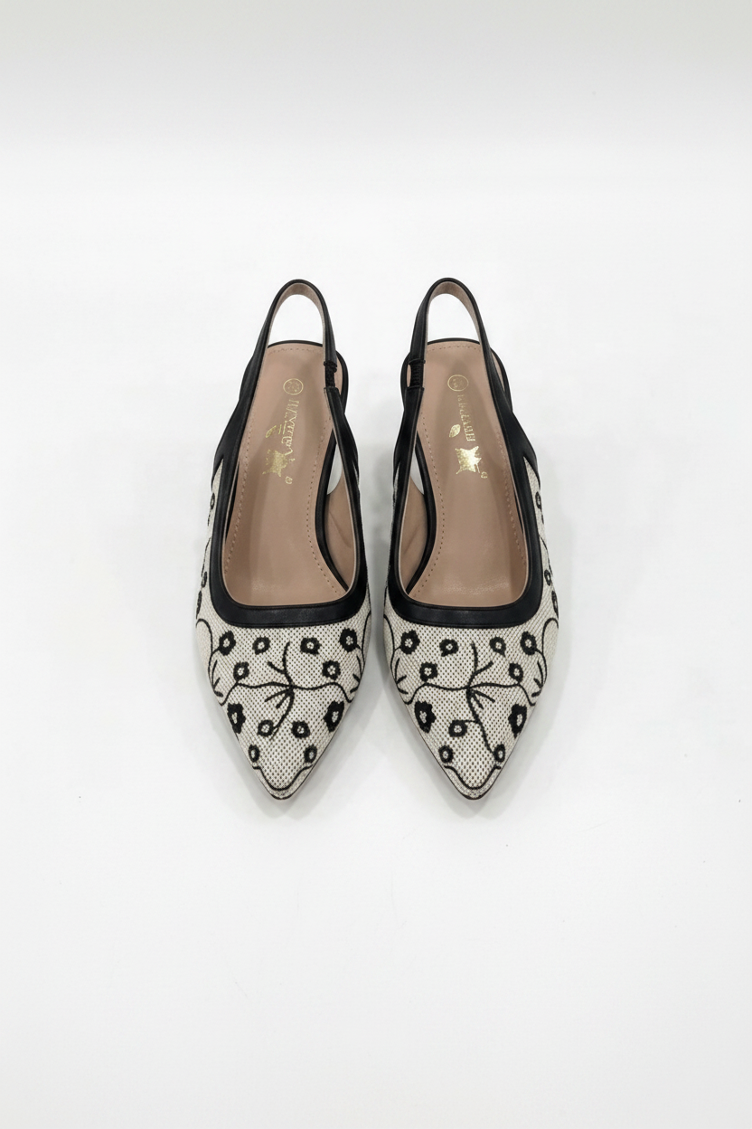 Black and white floral patterned shoes on a light gray background