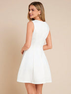 Woman wearing a white dress against a beige background