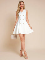 Woman wearing a white dress with gold buttons on a beige background