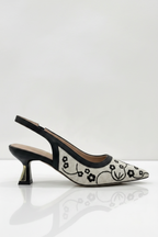 Black and white shoe with floral pattern on a white background