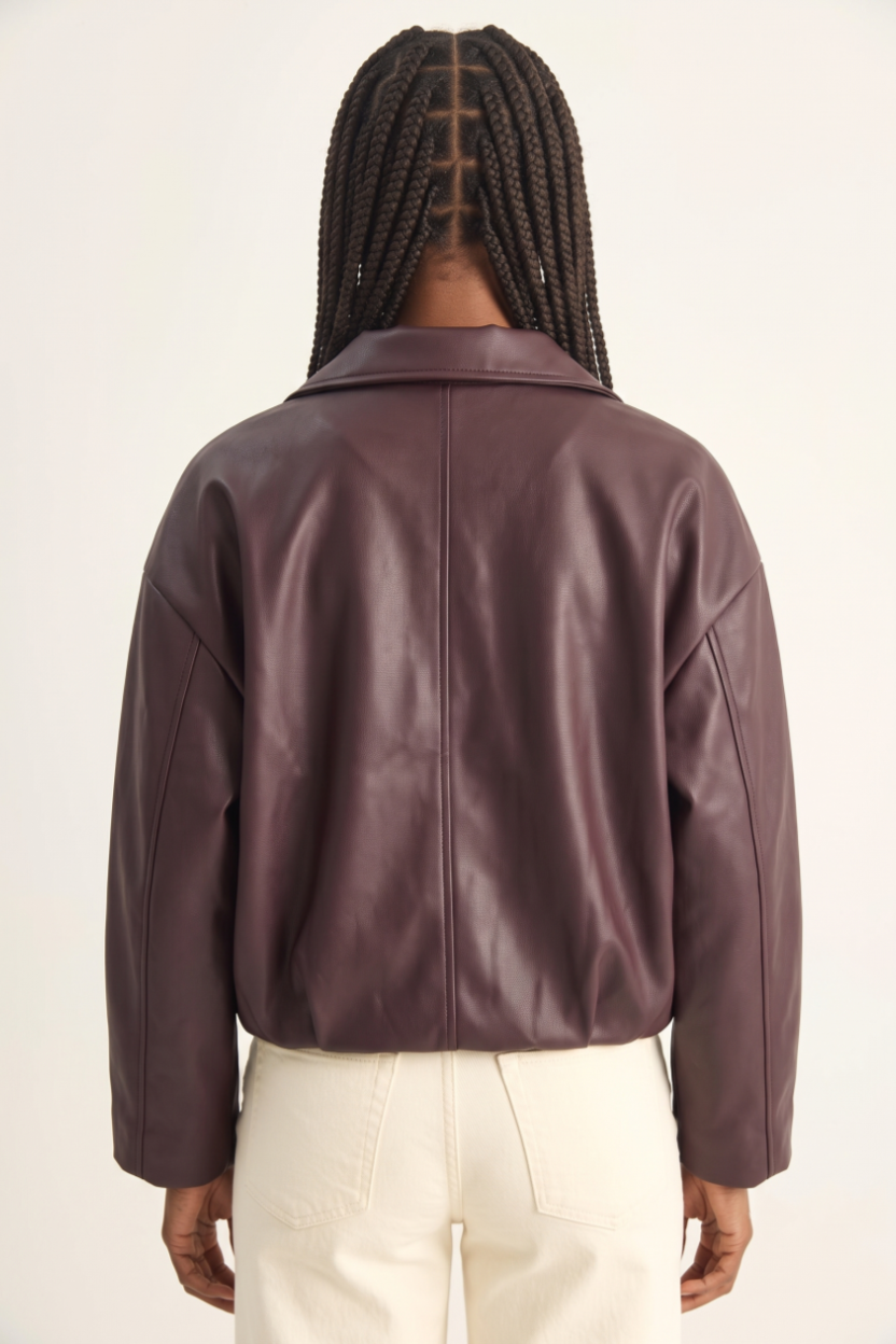 Person wearing a brown leather jacket on a white background