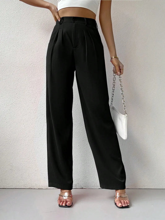 Person wearing black wide-leg pants with a white background