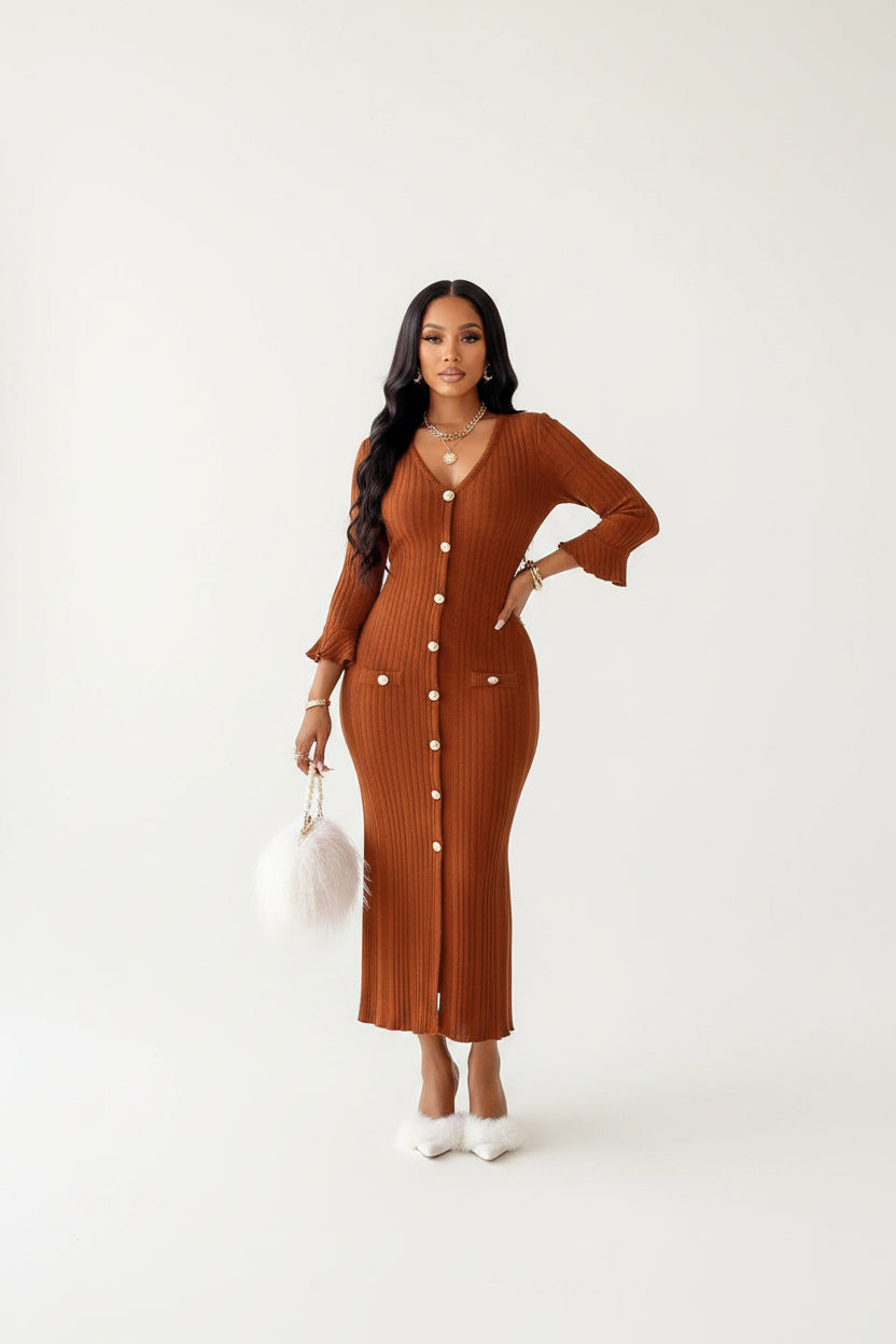 Woman wearing a brown ribbed dress with long sleeves in a bright room.